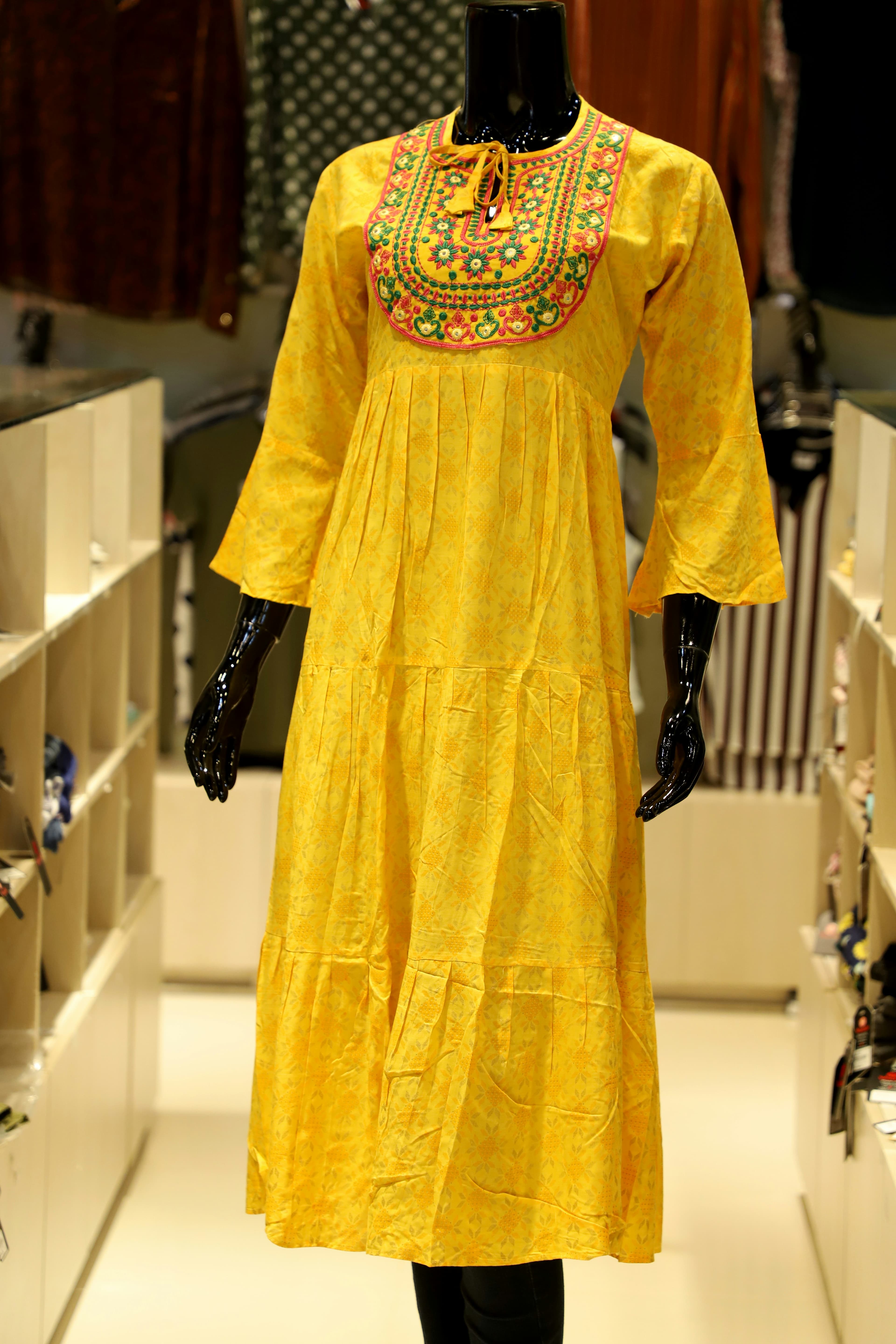 Woman in a festive kurti set with zari-edged dupatta