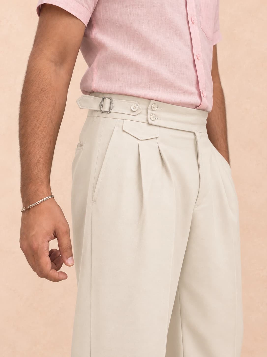 Cream pleated trousers — detail view