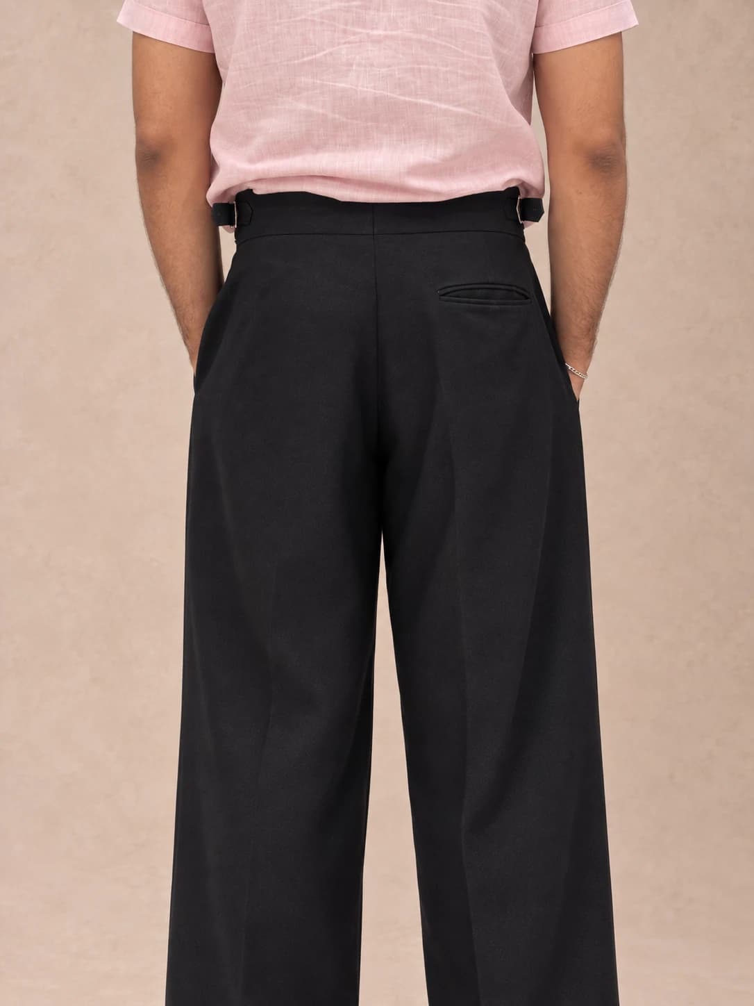 Black pleated trousers — back view
