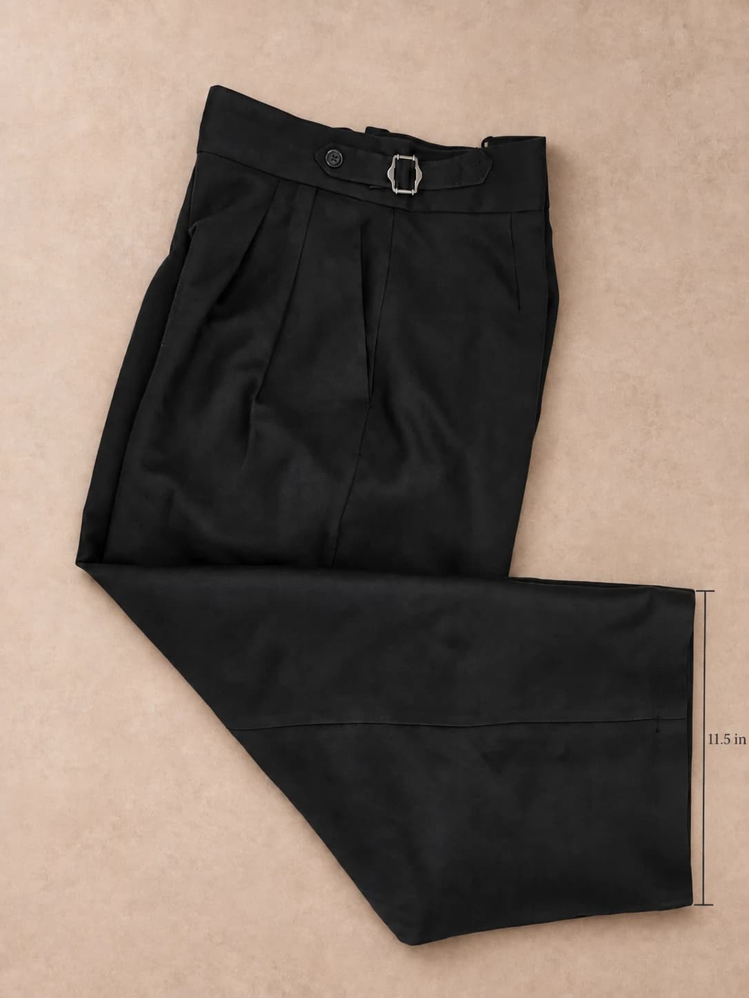Black pleated trousers — flat view